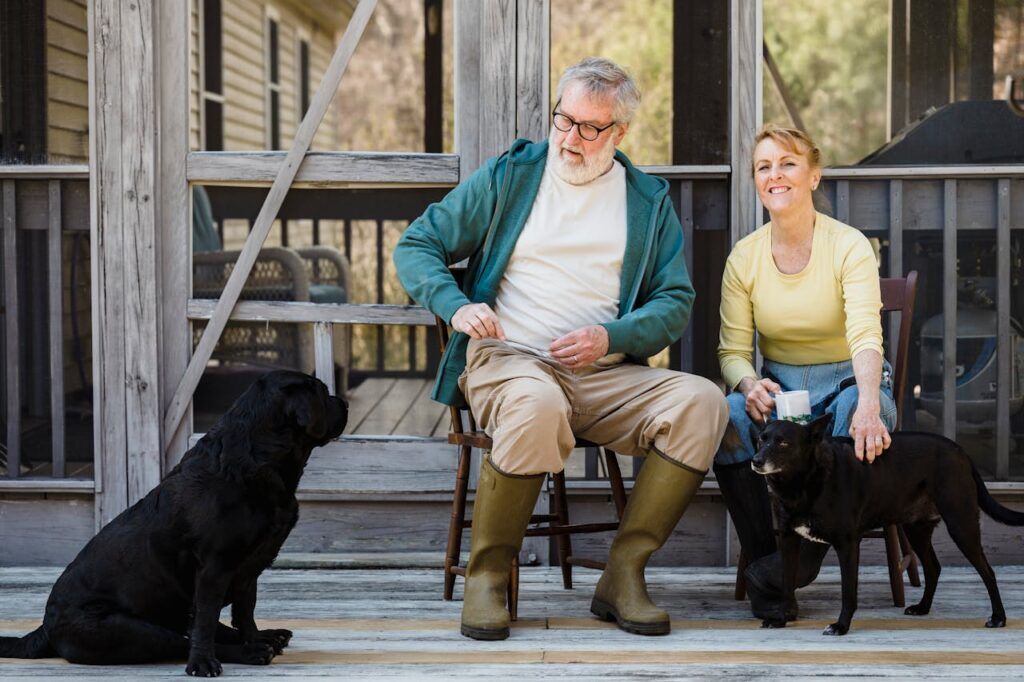 Senior Couple Sitting Together with their Dogs