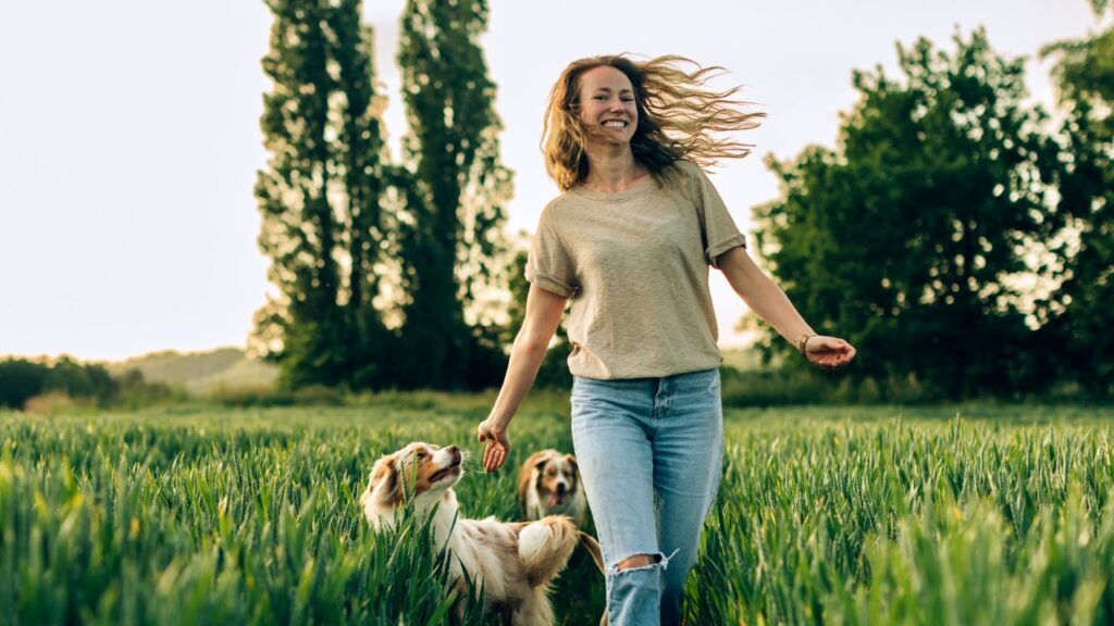 A Woman Playing with Her Dogs in a Park
