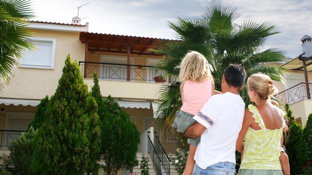 A Small Family Looking at their Home