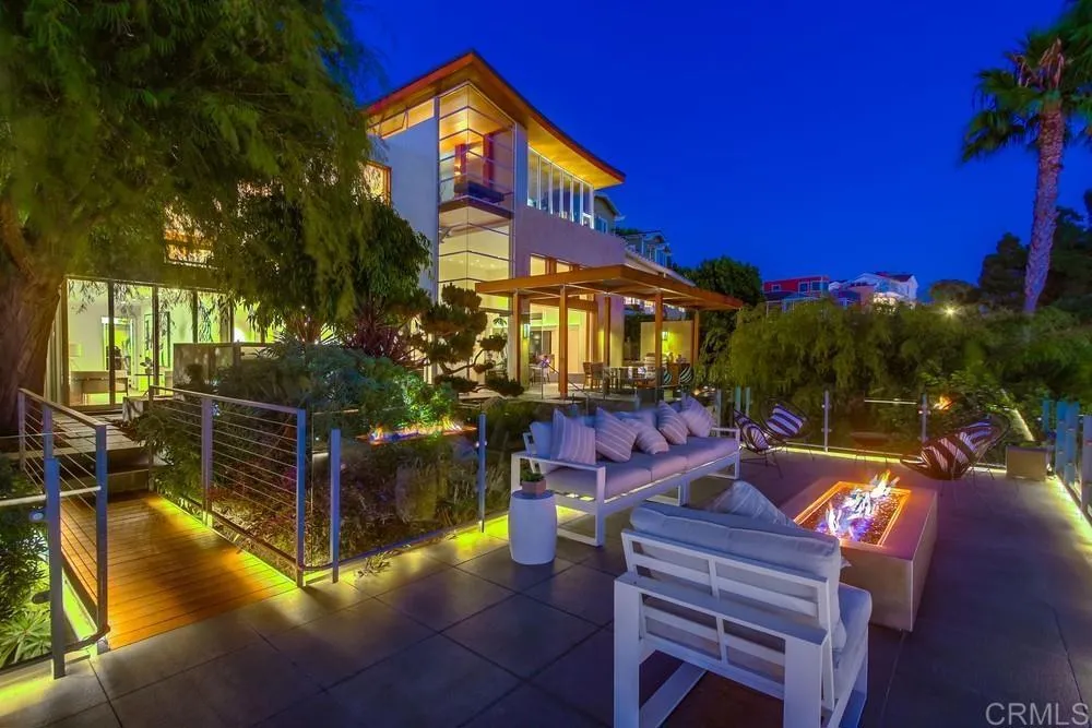 The Wave House SD is an architectural jewel, envisioned and brought to life by the award-winning firm Safdie Rabines Architects. Perched atop the prestigious Mission Hillsone of San Diegos most storied neighborhoodsthis contemporary masterpiece offers unparalleled vistas that will leave every guest captivated. Hosting gatherings or celebrations here ensures youll be the envy of all who visit. Located at 2477 Presidio Drive, the estate encompasses approximately 4,454 sq. ft. across a stunning main residence, a private casita, and a beautifully appointed pool house. The main home is anchored by a breathtaking 35-foot light-filled atrium, serving as a dramatic central axis that seamlessly connects all three levels while opening the entry to the terraced gardens below. The interiors are defined by soaring ceilings, curated living spaces, and walls of glass that blur the boundaries between indoor luxury and outdoor beauty. The family room, nestled into the hillside, extends effortlessly into lush gardens, while the elevated living room, dining area, and chefs kitchen are positioned to maximize panoramic bay views. Above it all, the primary suite reigns supremeyour private sanctuary in the sky. Additional highlights include: Top-of-the-line appliances and designer finishes Multiple balconies for seamless indooroutdoor living A custom fire pit for evening gatherings Exceptional spaces for both intimate moments and grand entertaining This home is more than a residenceit is a statement of modern design, a stage for unforgettable experiences, and a canvas for San Diegos most enviable